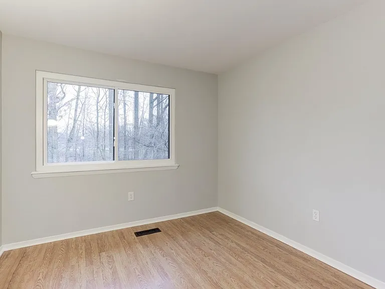 This versatile bedroom, featuring a large window that fills the space with natural light, can easily serve as a guest room, home office, or nursery. The closet has been recently updated with a modern sliding door.