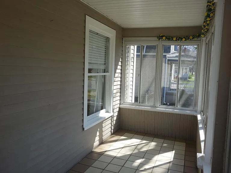 3 season front porch is a wonderful space to sit and enjoy life in Plymouth.