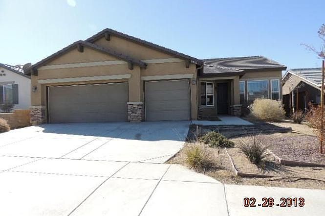 Landscaped front yard with 3 car garage.