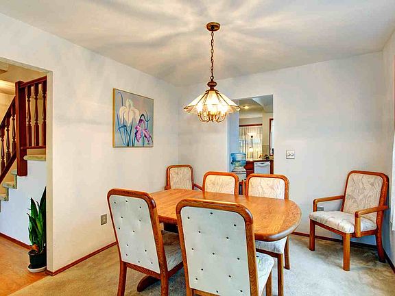 Formal dining room. To the left you can see the hardwood floors in the entry and the staircase to the upper level.