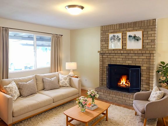 Living room with cozy wood-burning fireplace.