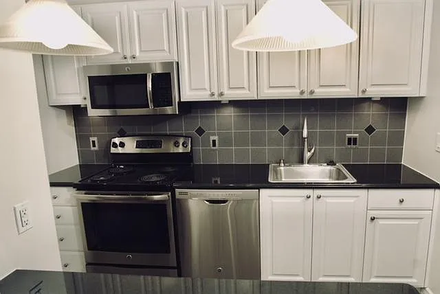 ONE BEDROOM KITCHEN AND BLACK GRANITE ISLAND