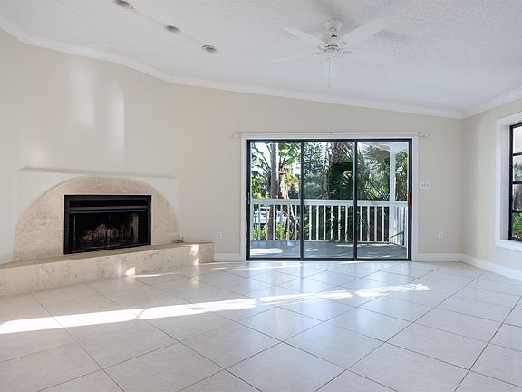 Spacious family room with fireplace overlooks the pool & Grand Canal.