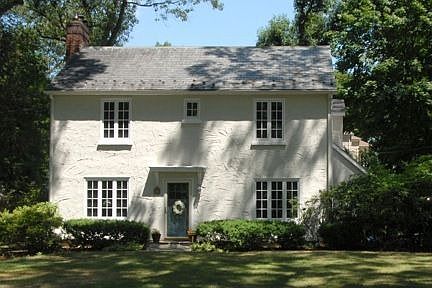 Picturesque Colonial with slate roof and stucco exterior