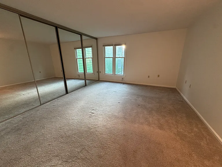 Master Bedroom includes floor to ceiling glass mirror doors with custom California Closet
