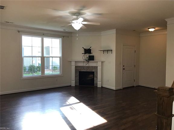 Another view of open great room with gas log fireplace.