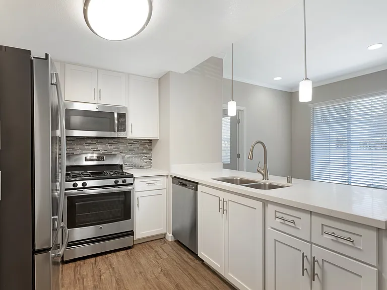 Our renovated kitchens open to the living room, creating a spacious flowperfect for hosting guests and enjoying seamless entertaining at Ascent at the Galleria.