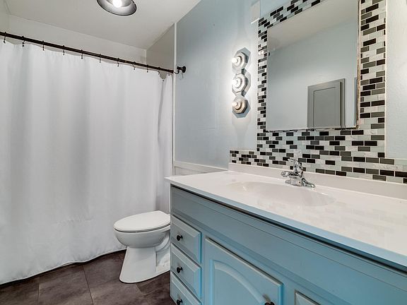 Newly remodeled bathroom: new sink, new tiles, new lights, new toilet, new floors, refurnished bath & cabinets