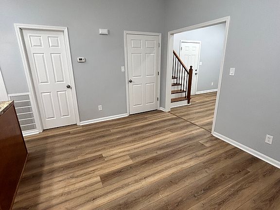 The dining room is between the kitchen and the living room. There is a large closet to the left of the staircase.