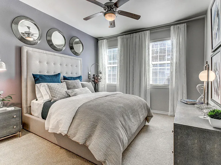 Large, luxurious bedroom with natural light.
