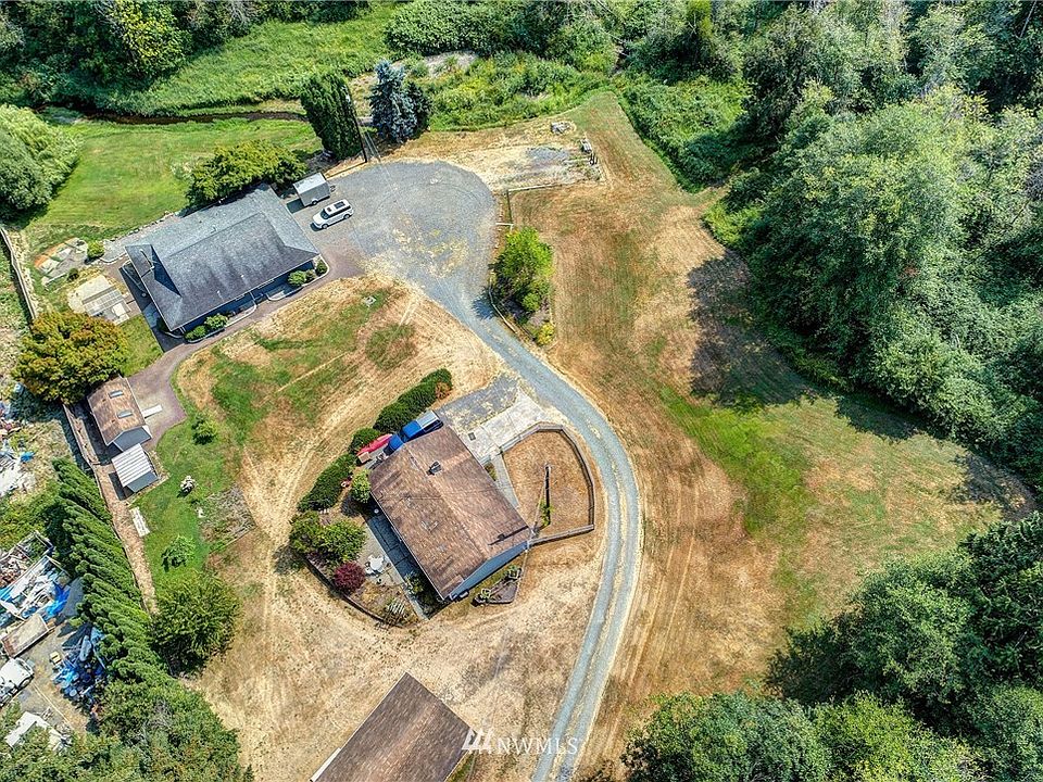7.6 Acres with 2 homes and outbuildings!