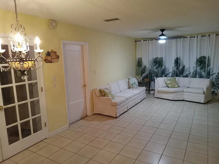 French doors to the left off the kitchen go into a private dining room with 2 sets of glass patio doors, that look out to the beautiful backyard and unique tropical Florida birds and wildlife, trees and flowers. It's paradise!
The view can't compare.