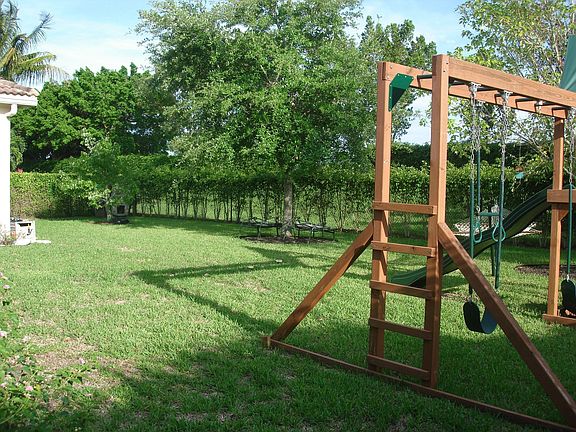 Large backyard with play set.