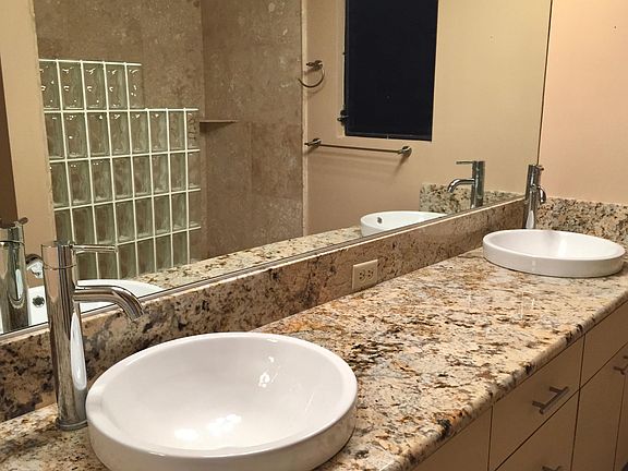 Bathroom with granite countertops and double sink area.