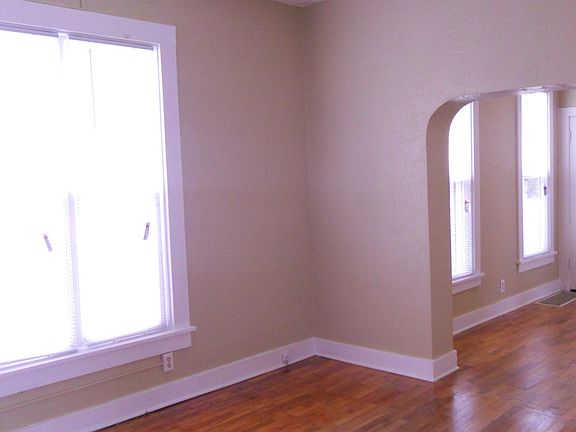 Living room into the dining room. Note the arched walk through and the ceiling fan