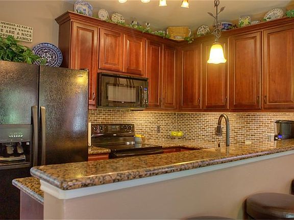 This kitchen could not be nicer!  Granite counter tops, stainless steel appliances, under cabinet lighting, track lighting, mosaic glass tile backsplash and more!