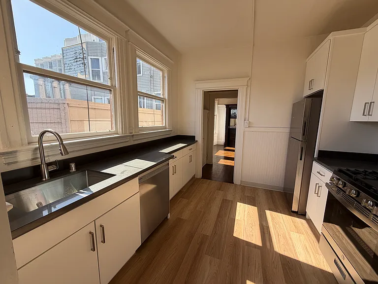 Urban views from the light and bright kitchen. Full size appliances, laundry room just off the kitchen.