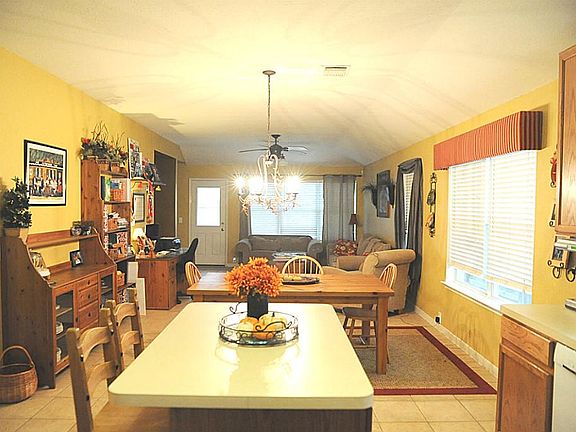 Custom paint throughout home. This view is looking from Kitchen to backyard.