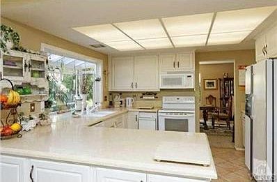 Lovely light and bright kitchen with Cesar stone countertops and Tile floor