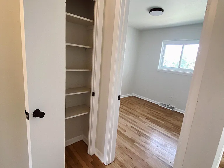 Linen closet and look into the second bedroom.