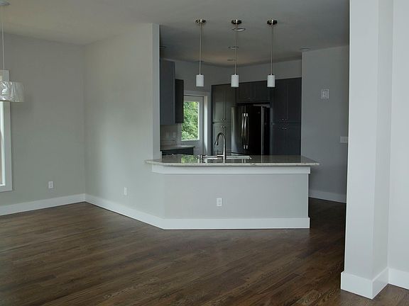 View from Front Door- open floor plan. Dining Room on left, Living Room on right.