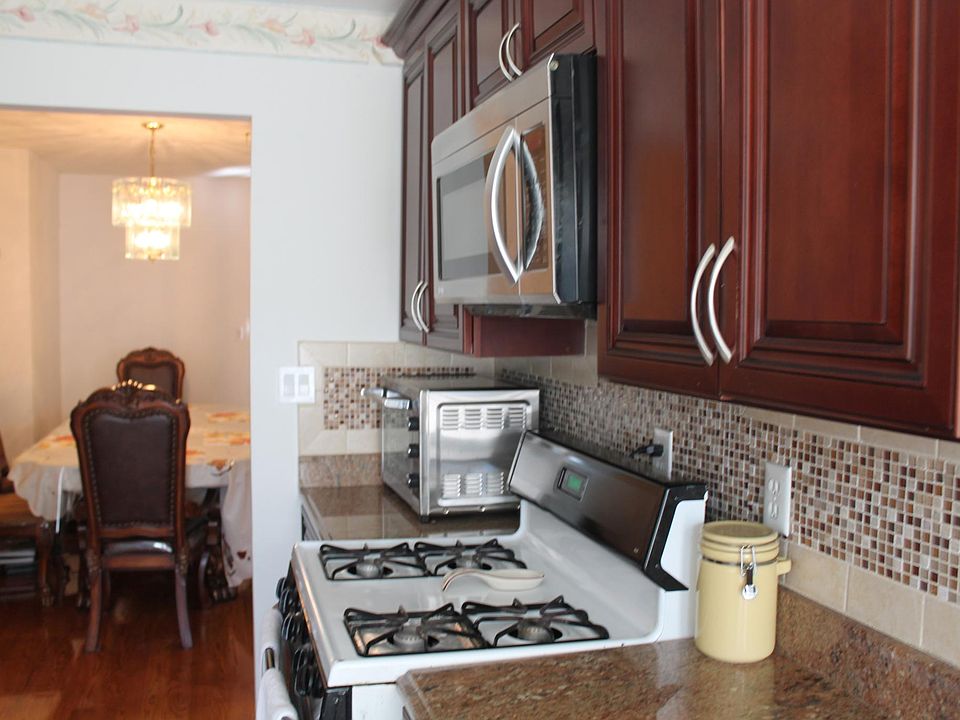 Kitchen with GE range, overhead LG microwave.