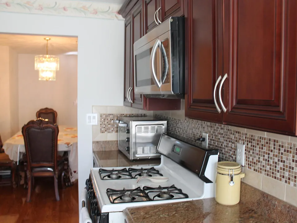 Kitchen with GE range, overhead LG microwave.