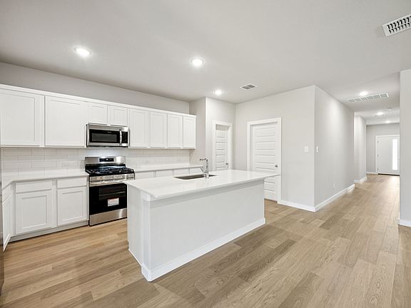 Kitchen in the Oscar home plan by Trophy Signature Homes - REPRESENTATIVE PHOTO