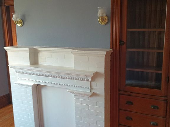 Beautiful fireplace and antique shelves and pull out drawers