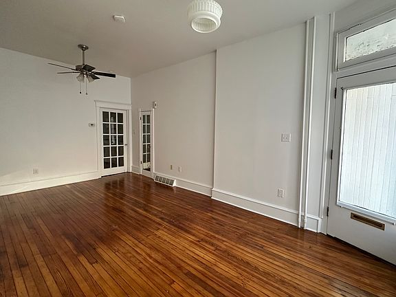 Living room with old storefront window. Room is 20'4" x 11'5".
