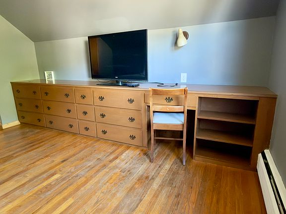 Bedroom 1: Deep built-in draws and designated workspace.