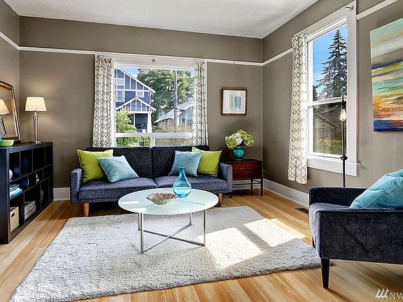 Large formal living room with picture rail & 9 ft ceilings, bathed in SW light.