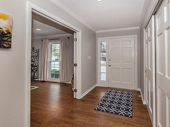 Roomy entry with wood floors, crown molding and large closet.