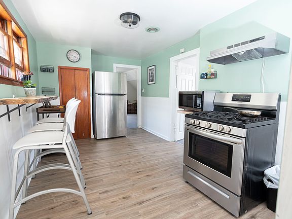 Kitchen with new LVP flooring, stainless steel appliances, and many more updates