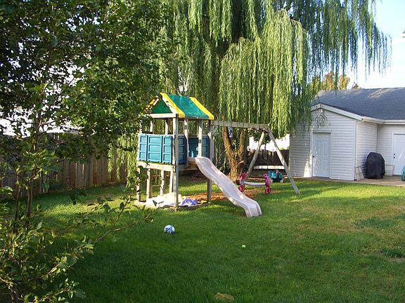 Large level fenced backyard -- and swingset stays!