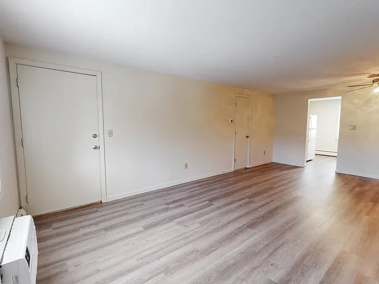Large modern Living room and dining area with Luxury Vinyl Plank flooring.