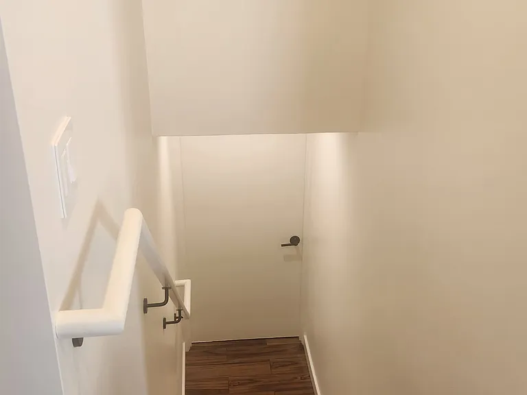 Stairs from the kitchen to the downstairs multi-use utility room and interior garage access.