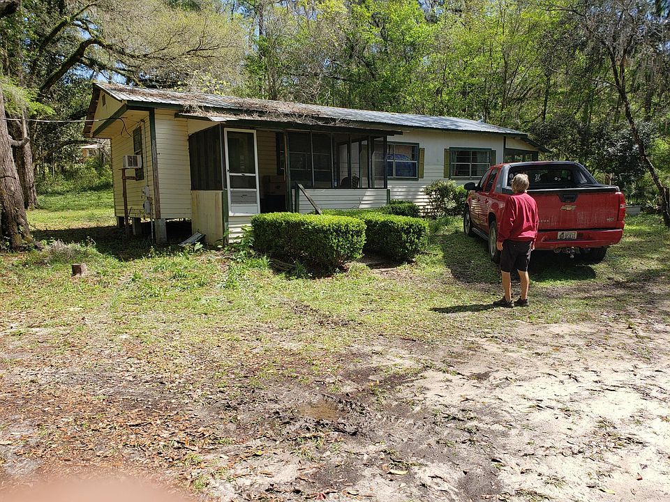 Front of the home. There are palms planted and other flowers. Screen porch in front and back. Will post more pictures