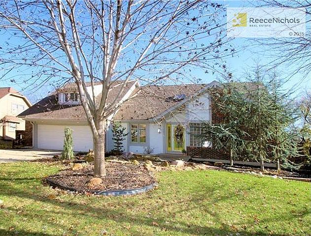 Custom landscaping for this stunning home with a newer exterior paint