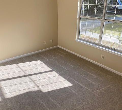 Master Bedroom with ceiling fan and new carpet