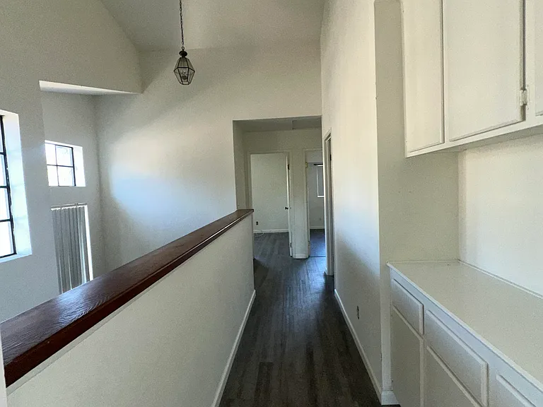 upstairs hallway with built in storage and lots of natural lighting