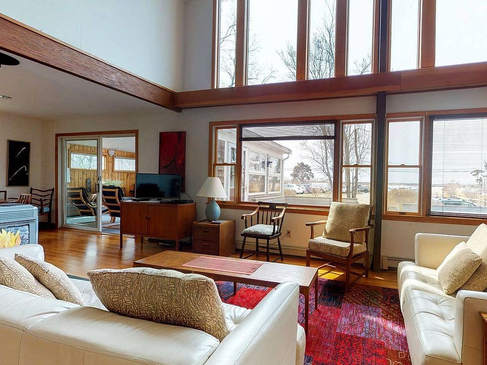 Living room overlooking deck, with views of Great Harbor.