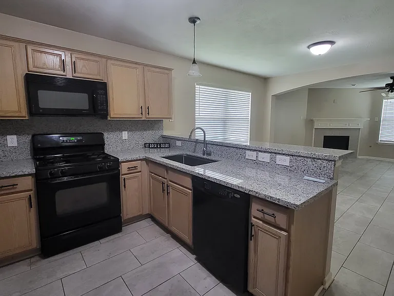 Kitchen with new granite counters and large single hole sink.