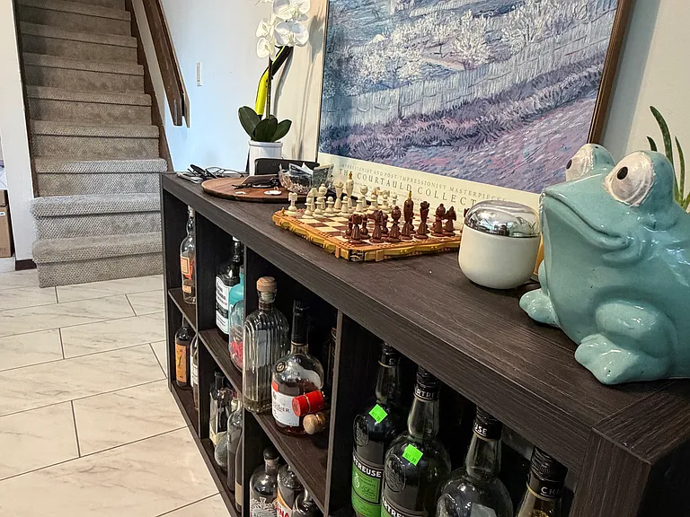 a corner area in the back right corner of the living room - a great space for a bar or children's play area
