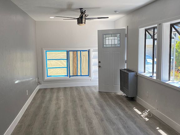 large living room with lots of natural light and 2 garden windows