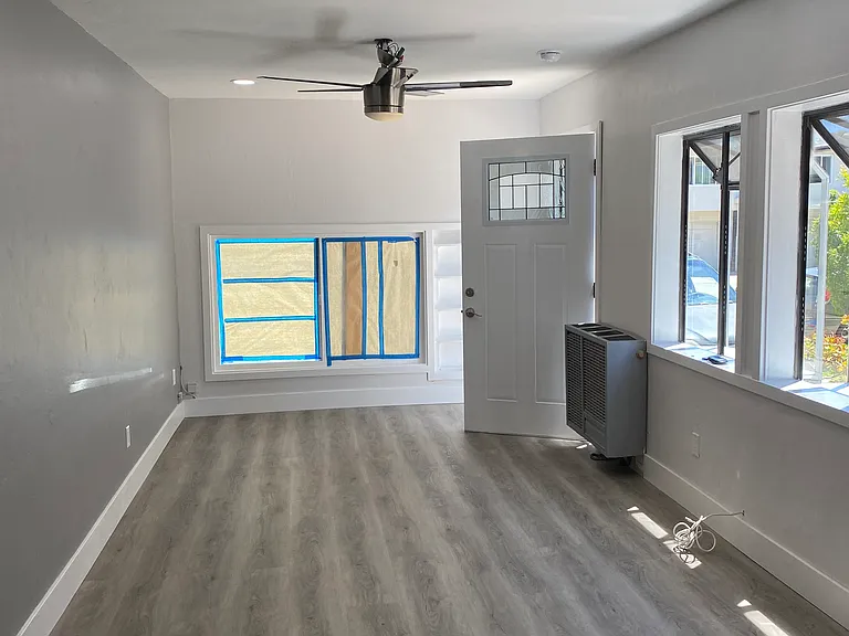 large living room with lots of natural light and 2 garden windows