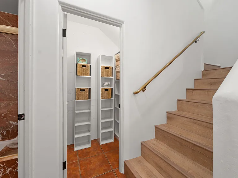 Entry closet and stairs to bedroom level