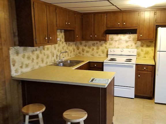 kitchen area with refrigerator and stove with additional cab