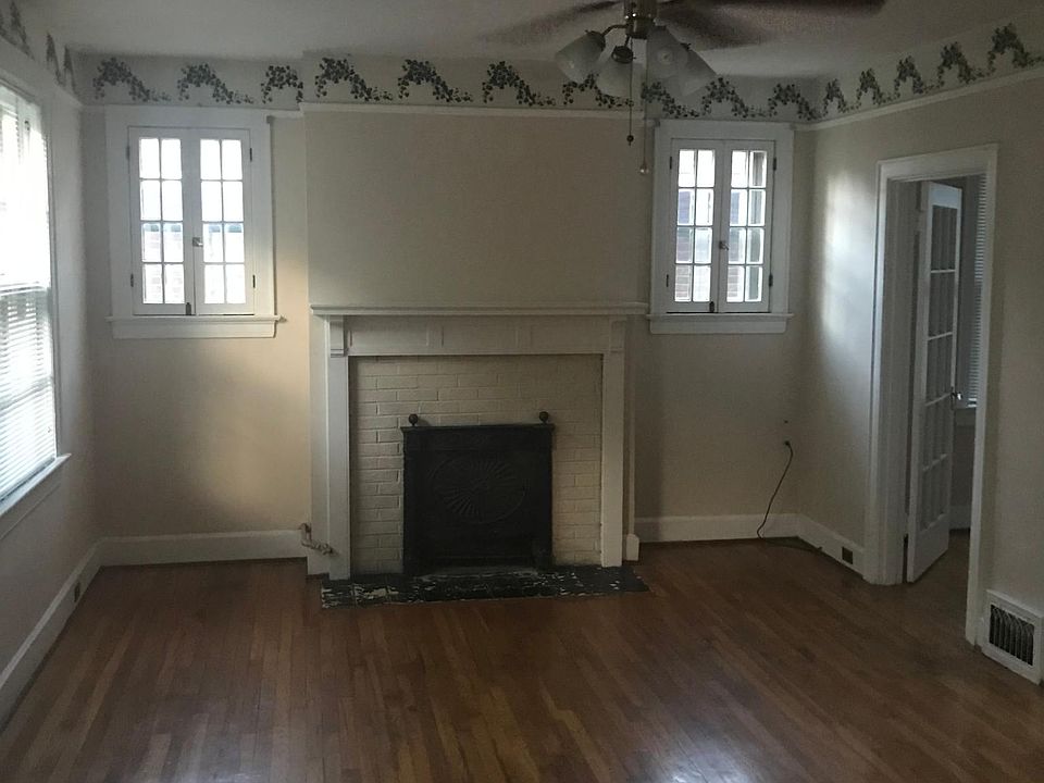 Large Living Room with ceiling fan and fireplace.