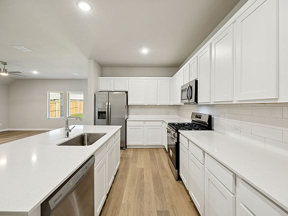 Kitchen in the Oscar home plan by Trophy Signature Homes - REPRESENTATIVE PHOTO